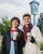 two boys standing infront of the dutch bros sign holding cold dutch bros drinks with Christmas sweaters