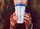 A close up picture of a person holding a dutch bros cup with mittens on